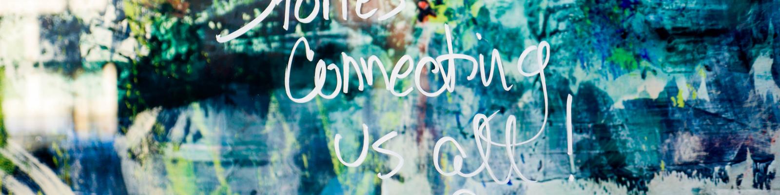 Painting with "Stories Connecting Us All" in words