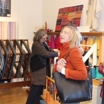 Umbrella artist Barbara Willis (right) welcomes Rep. Tami Gouveia and MCC's Anita Walker to her Studio