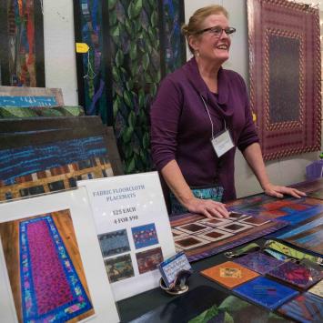 Vendor selling work at a holiday market