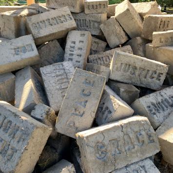 Pile of adobe bricks with words imprinted in them