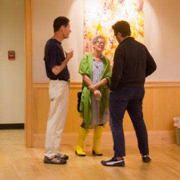 People looking at paintings in a gallery
